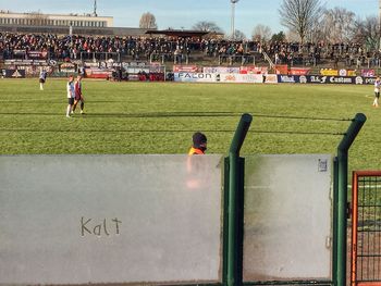 People playing soccer on field