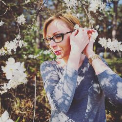 Woman standing by flowering tree