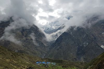 Scenic view of mountains against cloudy sky