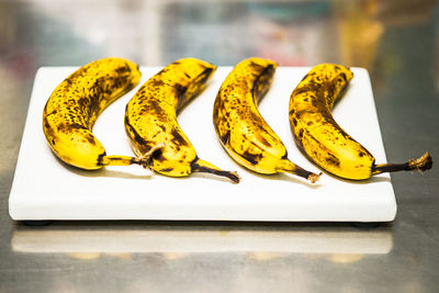 High angle view of bananas on cutting board at table