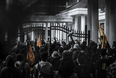 Rear view of people standing in corridor