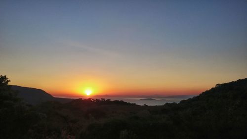 Scenic view of silhouette landscape against clear sky during sunset