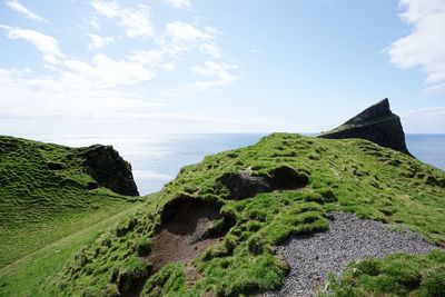 Idyllic shot of mountain and sea against sky