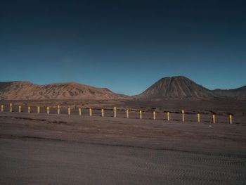 Scenic view of mountains against clear blue sky