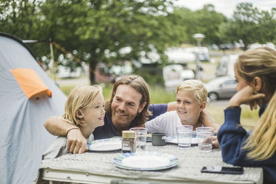 Portrait of friends sitting on table