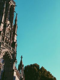 Low angle view of buildings against blue sky