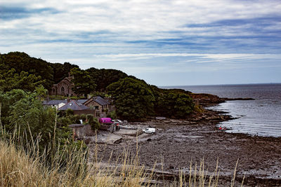 Scenic view of sea and buildings against sky