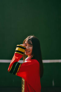 Portrait of smiling young woman standing outdoors