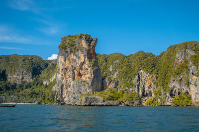 Rock formations in sea against sky