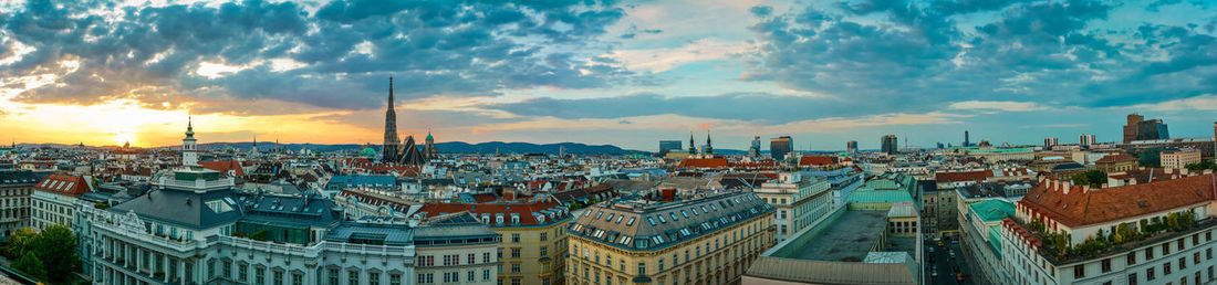 Panoramic view of cityscape against cloudy sky