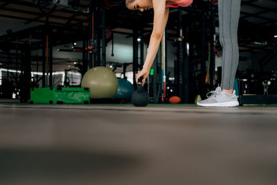 Low section of woman with ball on floor