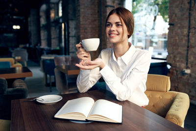 Woman holding coffee cup