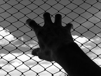 Close-up of a hand on a fence