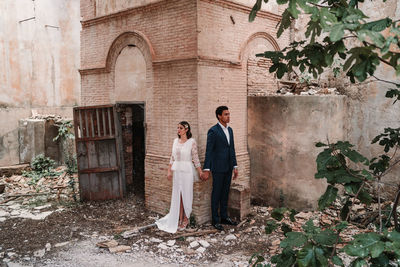 Couple standing against wall