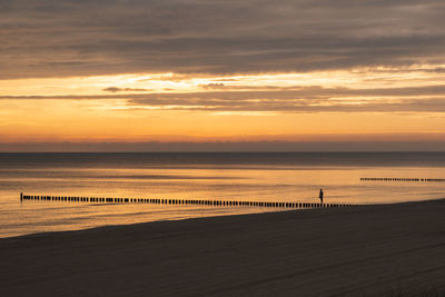 Scenic view of beach against sky during sunset