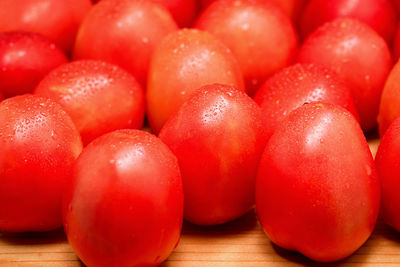 Close-up of wet tomatoes on table