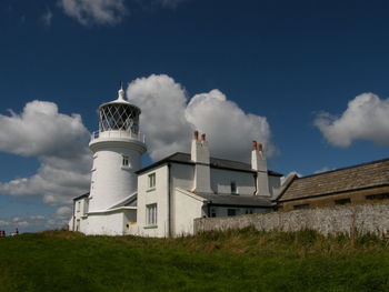 Lighthouse against cloudy sky