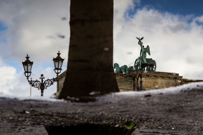 Reflection of brandenburg gate in puddle on street