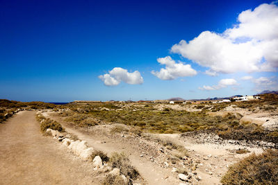Panoramic view of landscape against blue sky