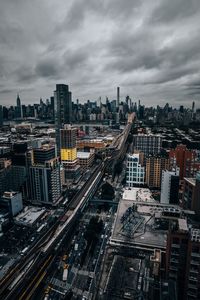 High angle view of street amidst buildings in city against sky