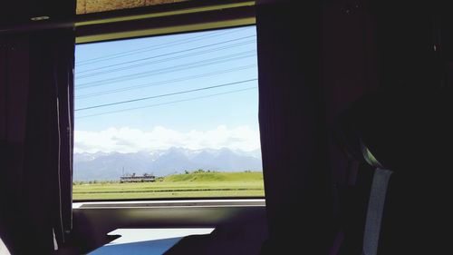 Scenic view of mountains seen through window