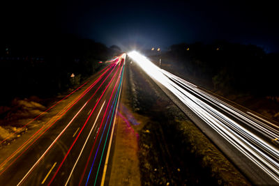 High angle view of light trails on highway at night