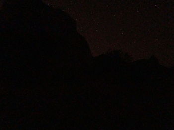 Low angle view of silhouette moon against sky at night