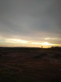 Scenic view of field against sky during sunset