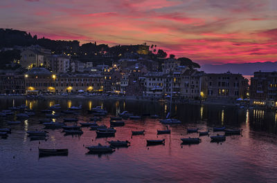 View of buildings in city at sunset