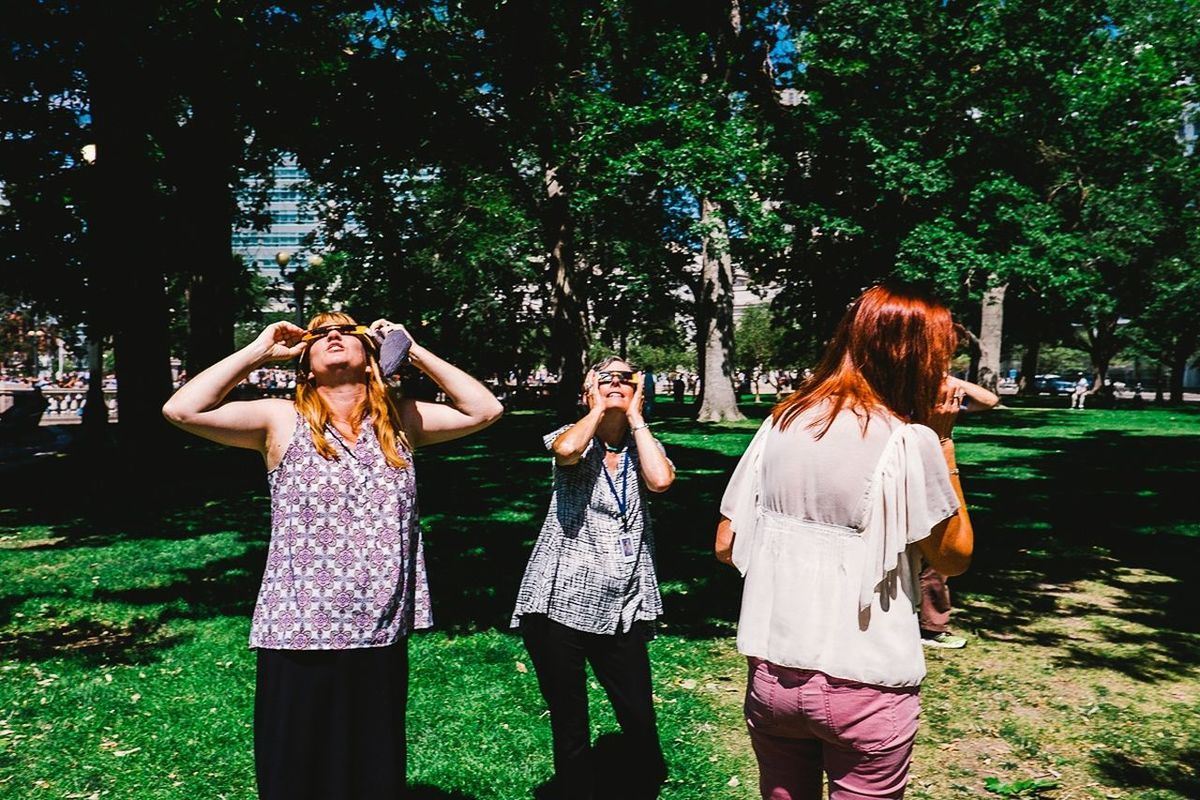 PEOPLE STANDING ON GRASS