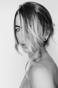 Close-up portrait of woman against white background