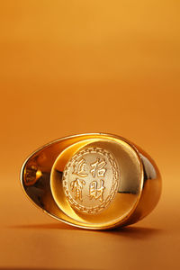 Close-up of electric lamp against orange background