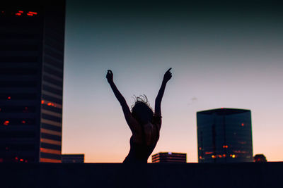 Beautiful girl enjoys sunset in the city