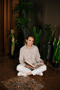 Portrait of young woman sitting at home