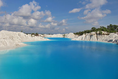 Scenic view of swimming pool by sea against sky