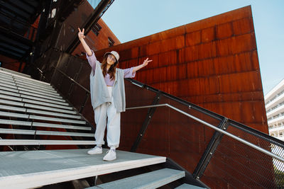 Beautiful and happy european girl having fun dancing break dance hip hop freestyle outdoors.