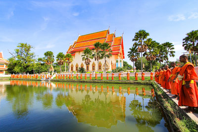 Reflection of temple in lake against sky