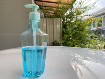 Close-up of glass of water bottle on table