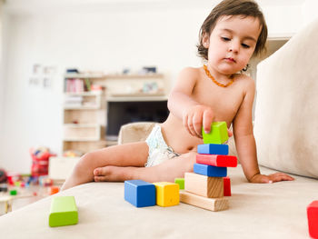 Portrait of girl playing with toy blocks