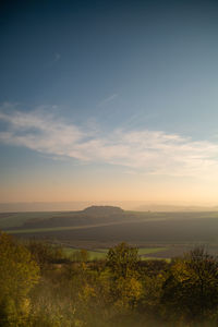 Scenic view of field against sky during sunset