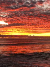 Scenic view of sea against romantic sky at sunset