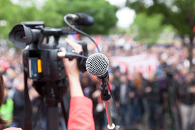 Cropped hand of person holding video camera