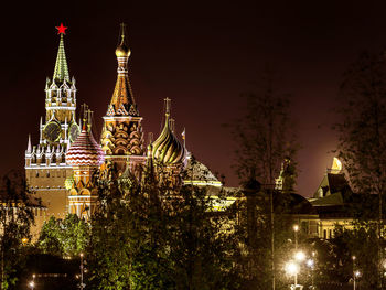 Illuminated traditional building against sky at night