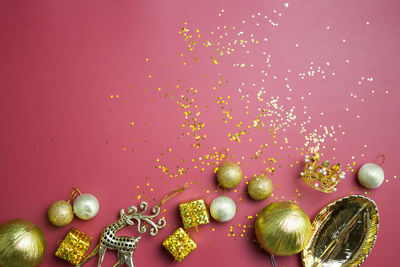 Directly above shot of christmas decorations on red background