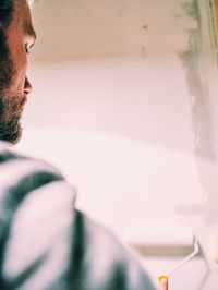 Cropped image of man painting wall at home