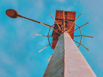 Low angle view of traditional windmill against sky