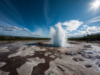 View of geyser on landscape