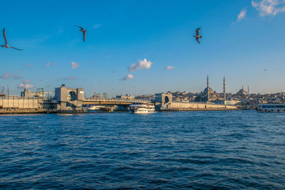 View of city by sea against sky