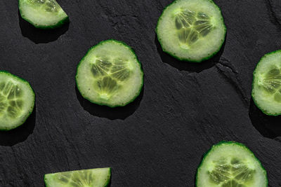 High angle view of green fruits against black background