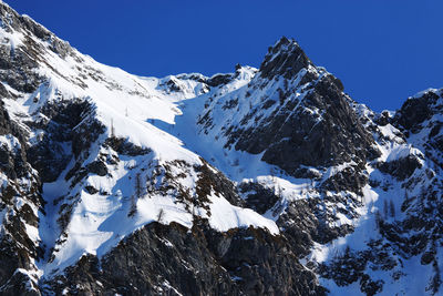 Scenic view of snow covered mountains against sky